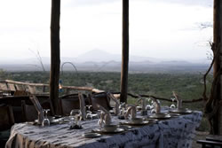 Dining at Kambi ya Tembo with a view to Mount Kilimanjaro Dining at Kambi ya Tembo with a view to Mount Kilimanjaro